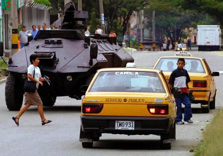Полицейский бронетранспортер патрулирует улицы Медельина,  Колумбия, 
в воскресенье, 26 мая 2002 г.  Фото и аннотация: Луис Бенавидес, 
агентство Ассошиэйтед Пресс.
