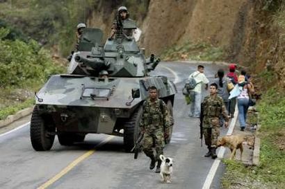 Колумбийские солдаты патрулируют дорогу в Эль-Пало, что около Торибио 20 апреля 2005 г. В окрестностях Торибио колумбийская армия и Национальня полиция в течение семи дней вели бои против повстанцев Революционных Вооруженных Сил Колумбии (FARC), в ходе которых четверо человек были убиты, и, кроме того, 30 человек были ранены в столкновениях. Фото и аннотация: Эдуардо Муньос, агентство Рейтер, среда 20 апреля 2005 г., 04 ч. 10 мин. всемирного времени.