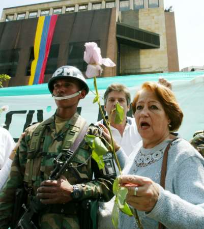 Колумбийская женщина выражает протест перед Ногаль-Клубом в Боготе, 10 февраля 2003 г. в ходе демонстрации против насилия и против взрыва автомобильной бомбы, устроенного в прошедшую пятницу. Свобода слова Колумбии рыдала но не была уничтожена автомобильной бомбой в пятницу, которая убила 33 человек в клубе Боготы, а Президент Альваро Урибе в воскресенье поклялся поторопить с ответными действиями вооруженные силы и ужесточить меры служб безопасности, направленные против марксистских повстанцев, крайне правых преступников и наркоконтрабандистов. Аннотация и фото: Хосе Мигель Гомес, агентство Рейтер; воскресенье, 10 февраля 2003 г., 12 ч. 56 мин. всемирного времени