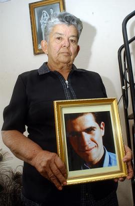 Ассенсьон Барахас держит фотографию своего мертвого внука, Джона Фредди Арельяна, в ее доме, в бедных окрестностях Боготы, Колумбия, 25 февраля 2003 г. В даном случае, который привлек внимание колумбийцев к задавленному горем семейству Арельяна, должностными лицами устанавливается, помог ли игрок в сквош устанавливать бомбу в Клубе Эль-Ногаль, в этом тяжелейшем для Колумбии за прошедшие десятилетия терракте. Ареллан погиб во время взрыва бомбы. Аннотация и фото: Фелипе Кайседо, агентство Ассошиэйтед Пресс со ссылкой на Эль-Тьемпо; суббота, 01 марта 2003 г., 04 ч. 38 мин. всемирного времени