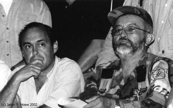 Grim faced, Camilo Gomez, the Governments High Commissioner for Peace and Raúl Reyes during negotiations at Los Posos, 
Caquetá in the last days of the peace process
Photo: Jason P.Howe, 2002 .