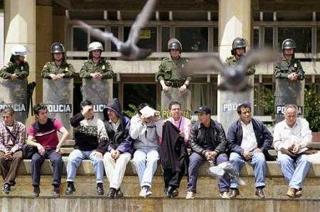 State workers sit in front of the Justice Palace in Bogota while attending a demonstration 
during a national strike to protest President Alvaro Uribe's austerity program in Bogota, 
Colombia Monday, Sept. 16, 2002. (AP Photo/Zoe Selsky)