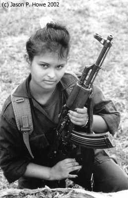 A female rebel poses with her Egyptian made AK47 in a camp in Caqueta.
Photo: Jason P.Howe, 2002