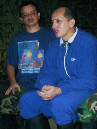 Офицеры колумбийской полиции Либардо Фореро (слева) и Луис Мендьета (справа), которые удерживаются в плену, 
были похищены пять лет назад и сфотографированы в джунглях 26 июля 2003 г. 
Сегодня, после того, как лидер повстанцев заявил о том, что казнит пленников в случае попытки их освобождения, 
члены семей группы политических деятелей и военных, взятых в плен бойцами РВСК-АН, потребовали, чтобы колумбийское 
правительство пошло на соглашение, которое позволило бы пленникам обрести свободу. Фото и аннотация Энрике 
Ботеро, агентство Рейтер, 26 августа 2003 г., вторник, 26 августа 2003 г., 16 ч. 07 мин. всемирного времени 