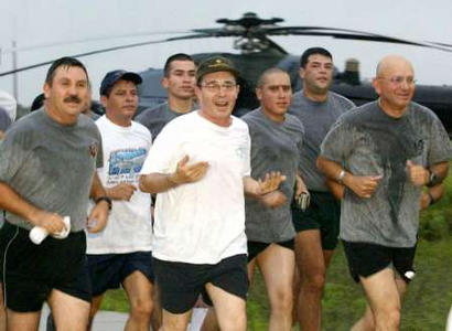 Колумбийский президент Альваро Урибе (в центре) ранним утром командует собственным сопровождением в ходе физических упражнений, будучи в компании главнокомандующего колумбийской армией  генерала Карлоса Оспины (справа) и армейского генерала Карлос Лемуса (слева) на военной базе в городе Араука одноименного департамента 16 июля 2002 г. Урибе, пытаясь найти способ продемонстрировать его разделенную войной нацию управляемой, будет на этой неделе командовать Колумбией из Арауки, области насилия в самом сердце поддерживаемой США борьбы против марксистских мятежников. Фото и аннотация: Элиана Апонте, агентство Рейтер, среда, 16 июля, 8 ч. 16 мин. всемирного времени